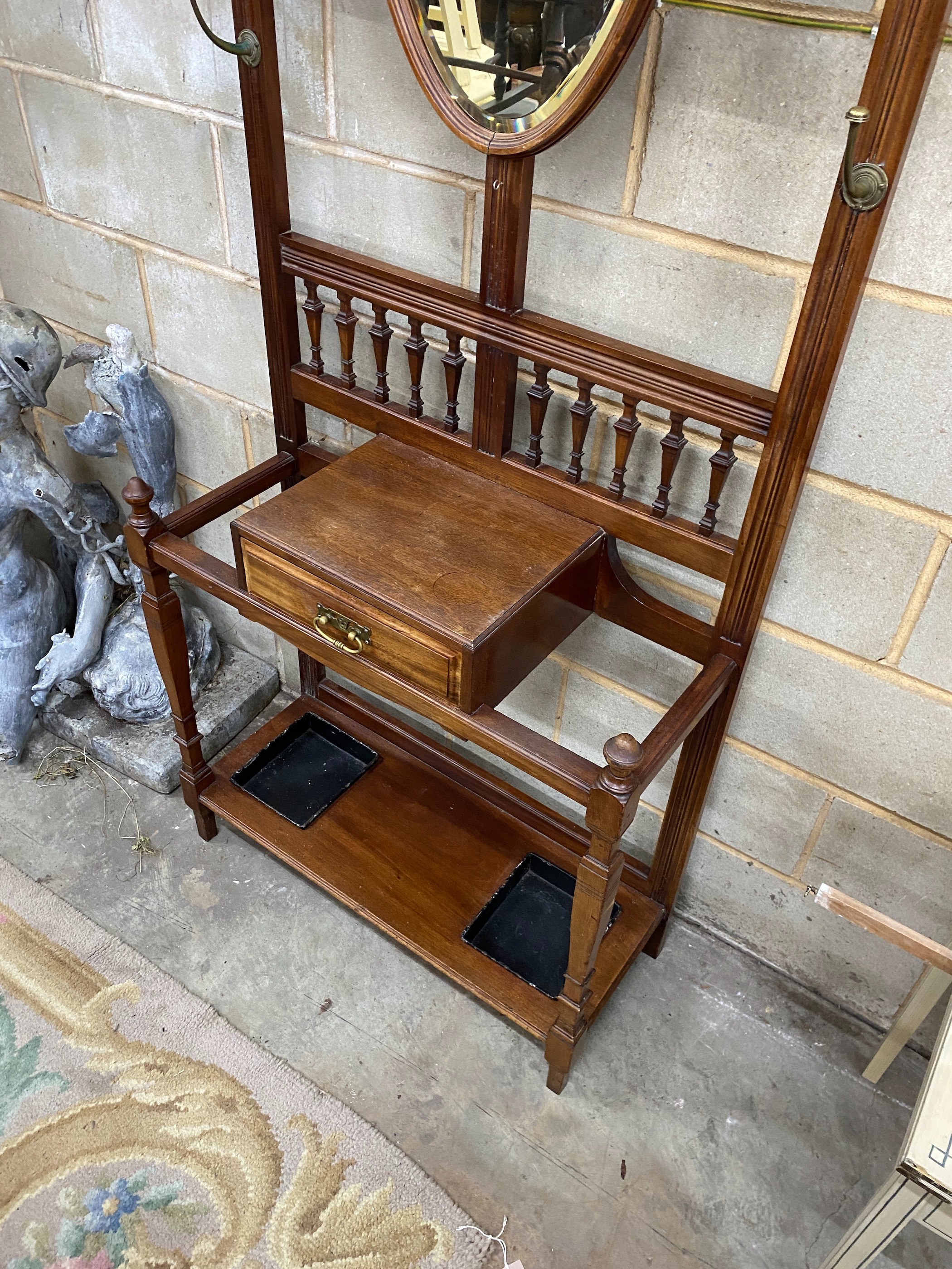 A late Victorian mahogany hall stand with shield silvered mirror, width 84cm, height 203cm